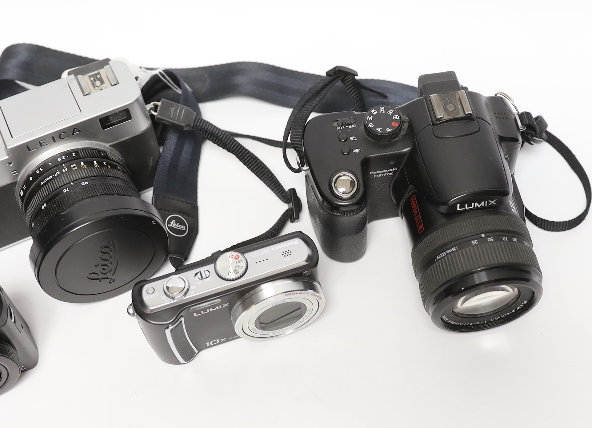 Four digital cameras; a Leica Digilux 2 and three Panasonic Leica models from the LUMIX series